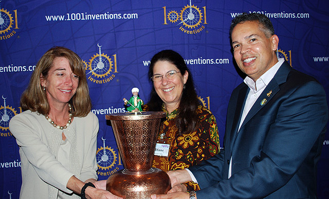 Dr. Diane Perlov (center) and William Harris (right) present the Scribe Clock to Kathryn Kean of National Geographic